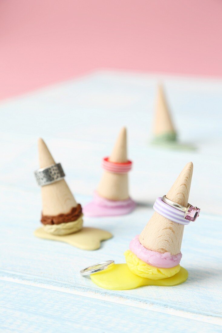 Rings placed over miniature ice-cream cones made from wood and modelling compound