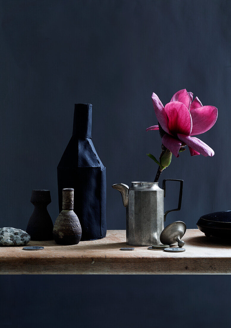 Deep pink magnolia flower in old pewter coffee pot