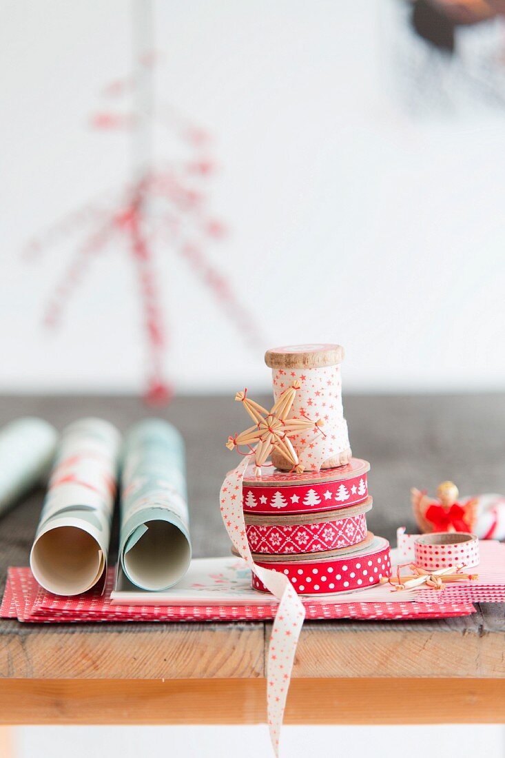 Ribbons in shades of red and Christmas wrapping paper