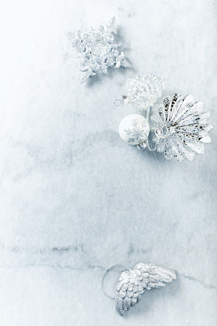 Silver Christmas decorations on marble surface