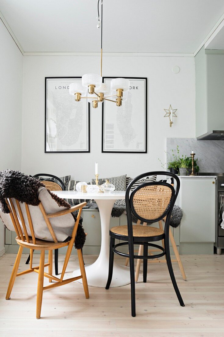 White Tulip Table, black bentwood chairs and retro lamp in dining area