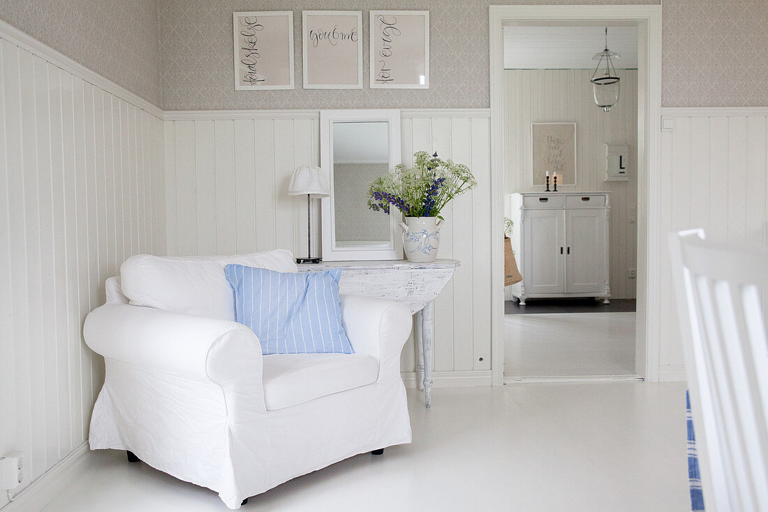 White armchair against wainscoting