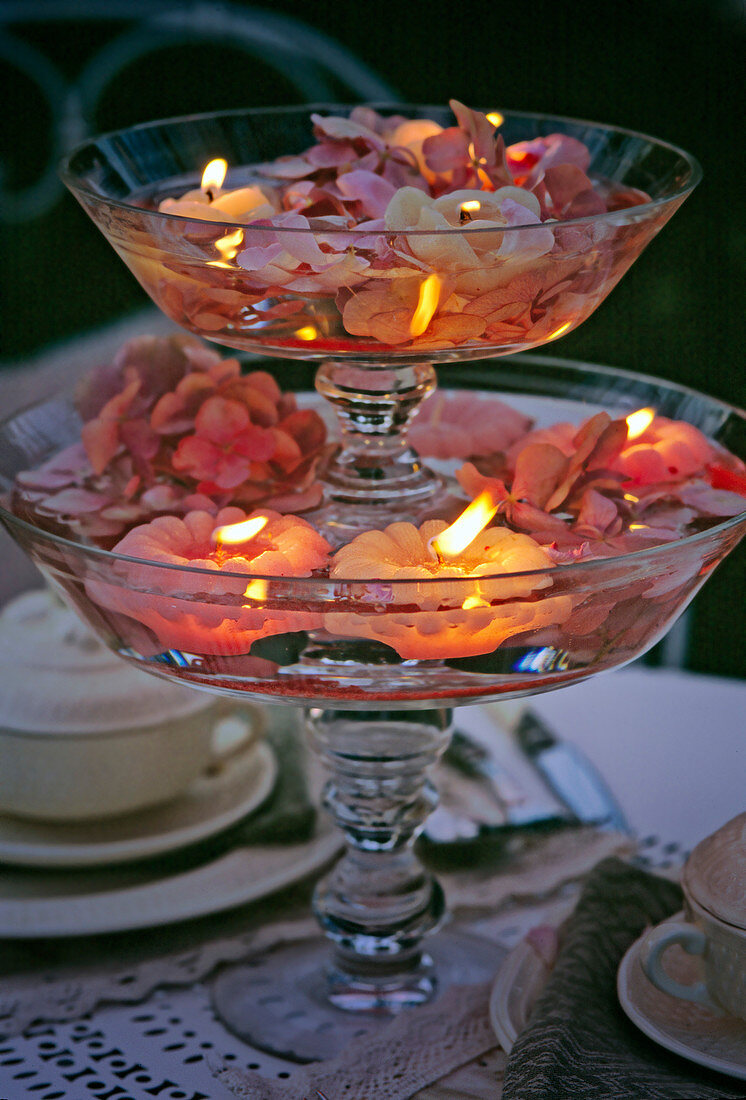 Glass bowls stacked with floating candles