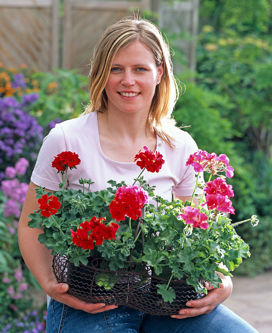 Young woman with freshly cooked geraniums