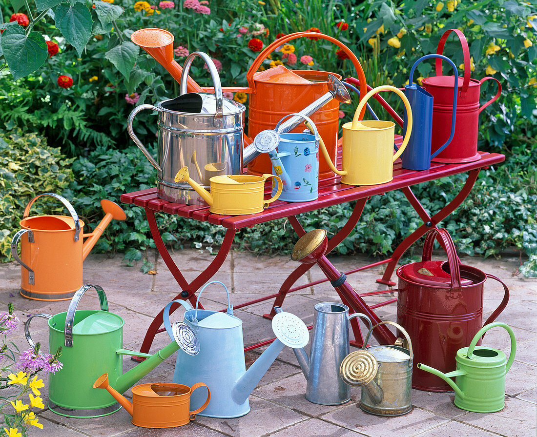 Metal watering cans in different colors and shapes