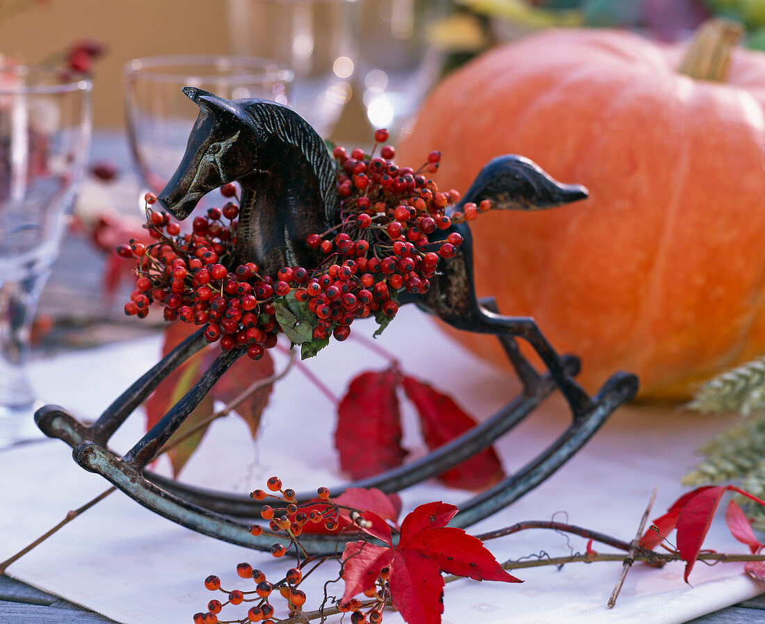 Metal rocking horse with wreath of roses, Parthenocissus