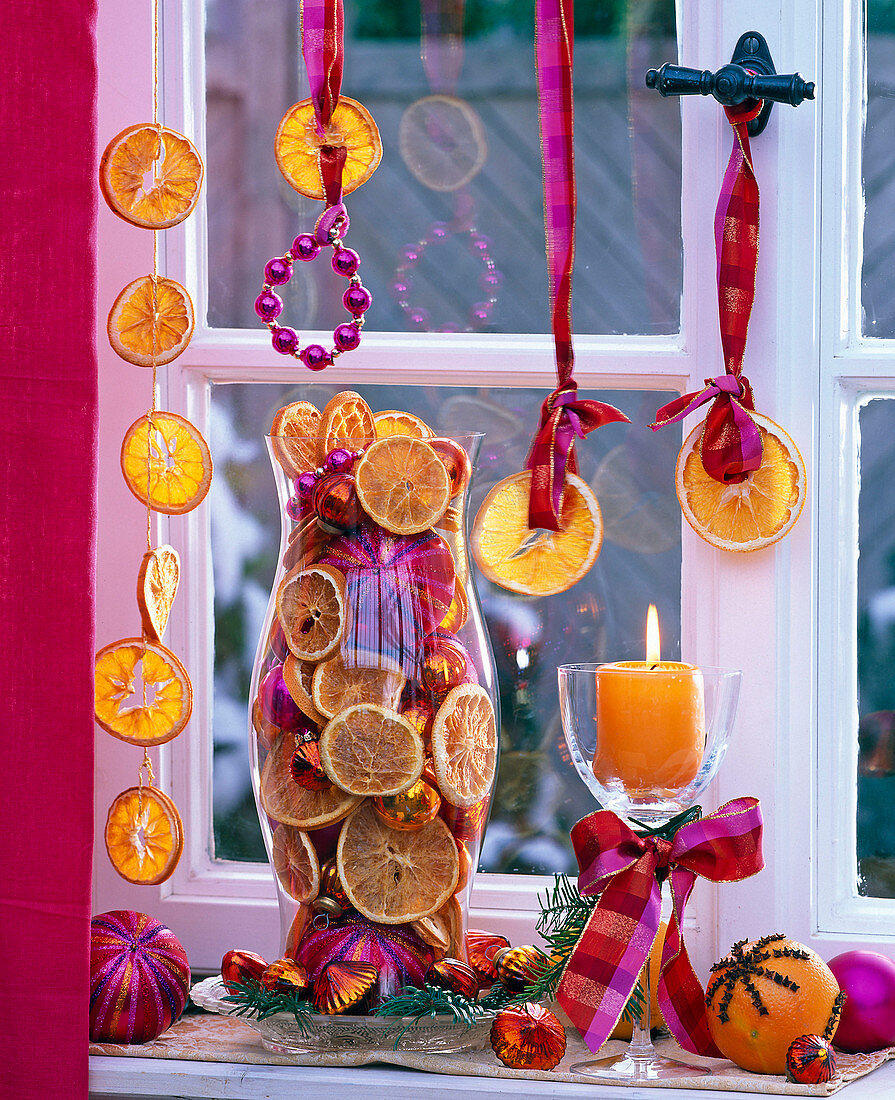 Glass jar at the window, filled with citrus