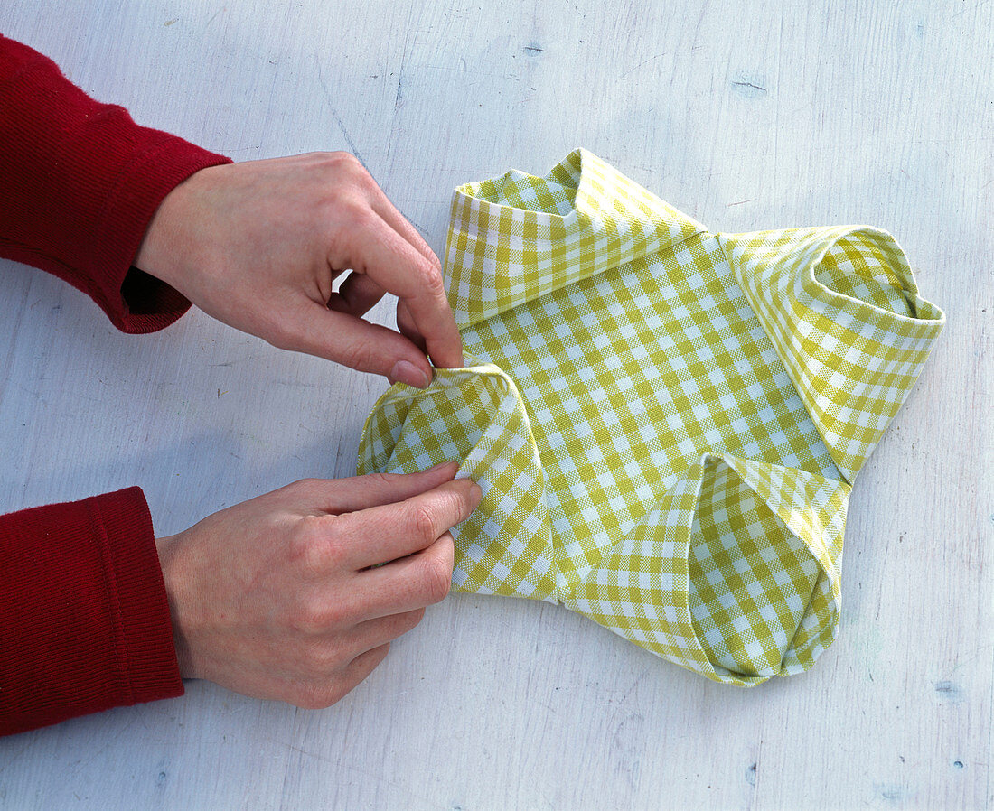 Fold green and white checkered cloth napkin