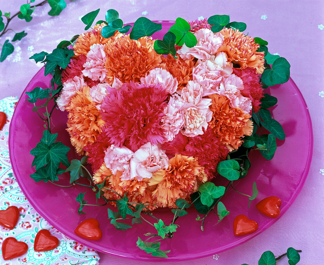 Dianthus (carnation) flowers in heart of Oasis on glass plate