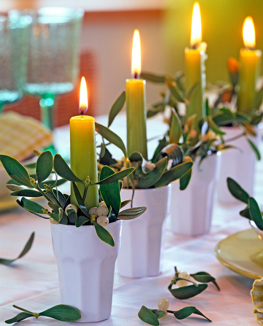 Arrangement with mistletoes and candles