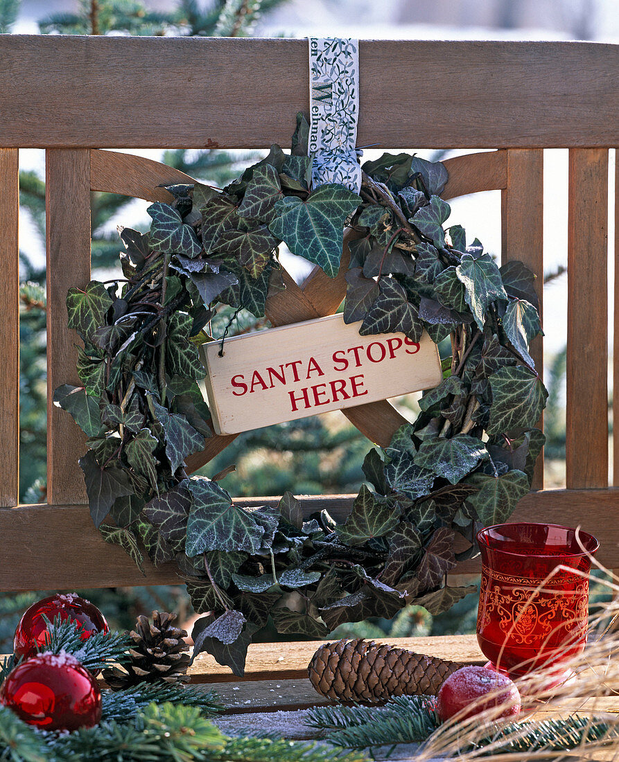 Hedera wreath, hung on a wooden bench with ribbon