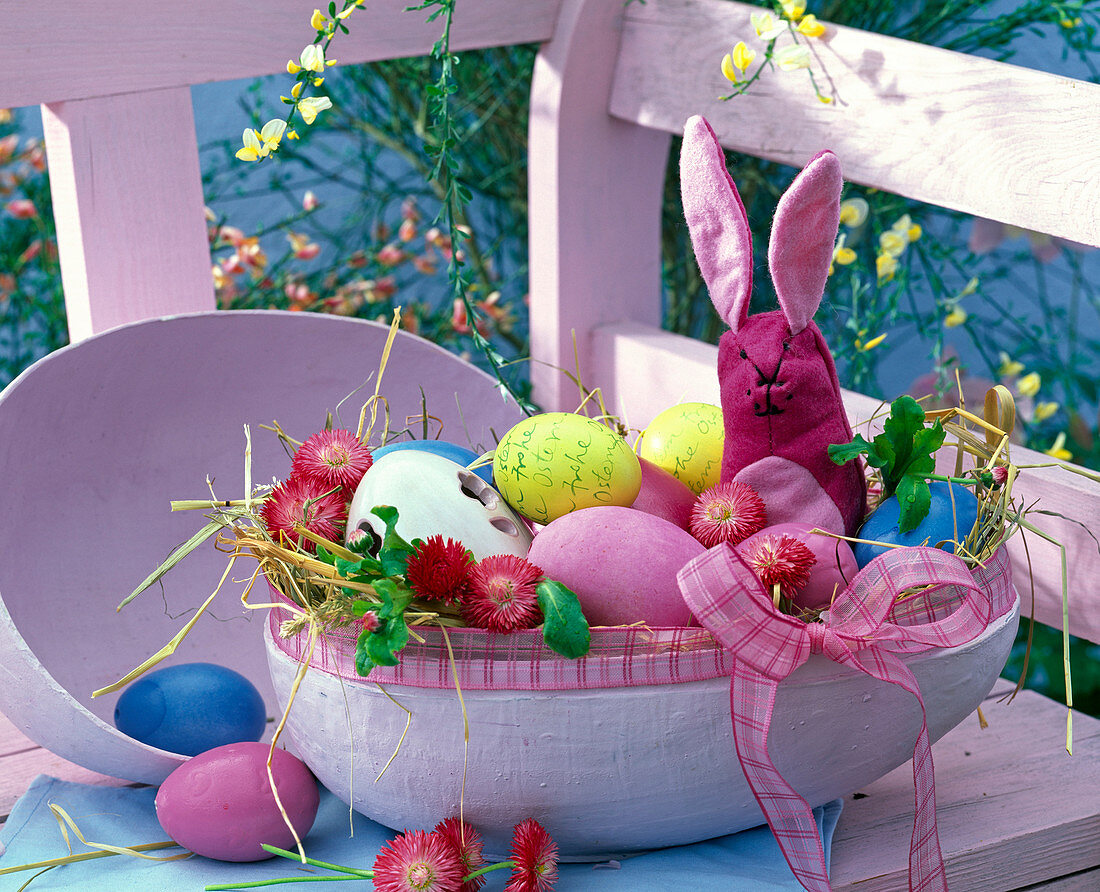 Rose cardboard Easter egg as easter nest with bellis, easter eggs