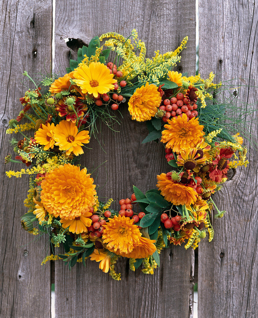 Late summer wreath with marigolds and rowanberries