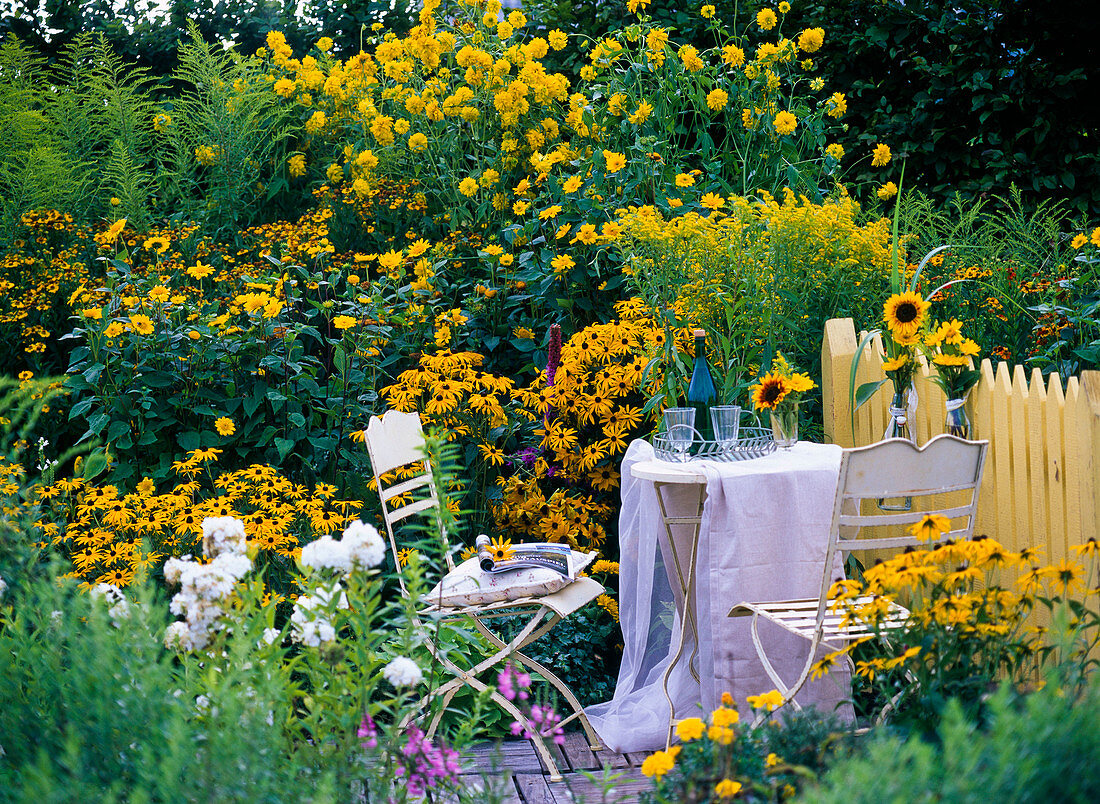 Seating area at the late summer yellow bed
