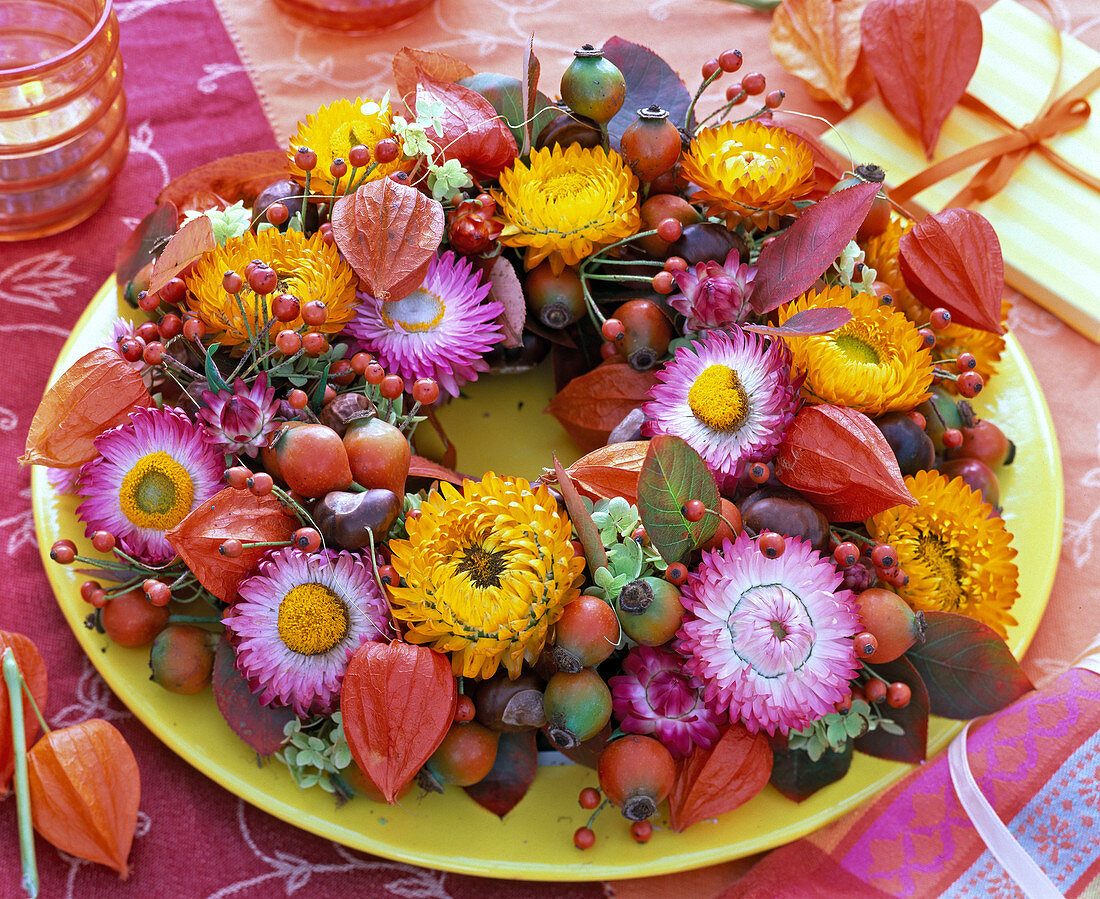Autumn wreath with berries, fruits, leaves and flowers