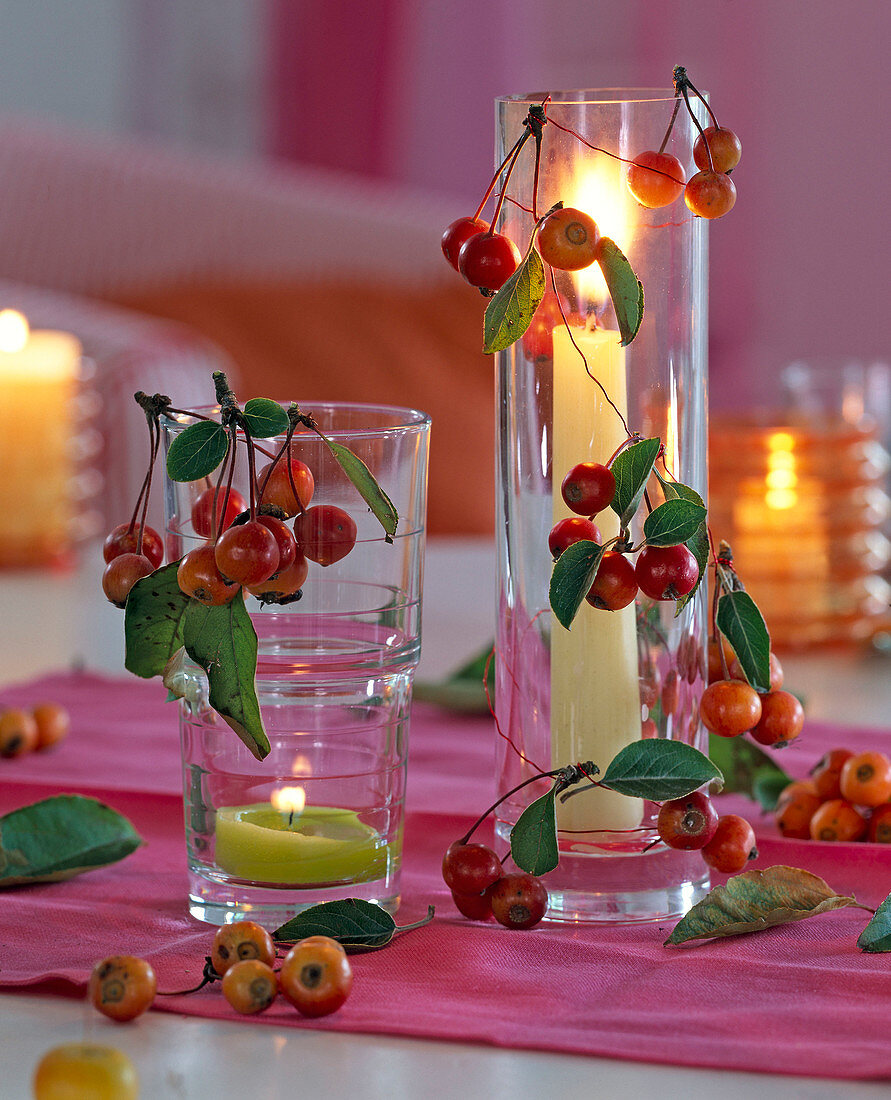 Malus (rote Zierkirsche) an Windlichtern mit grüner und mit weißer Kerze