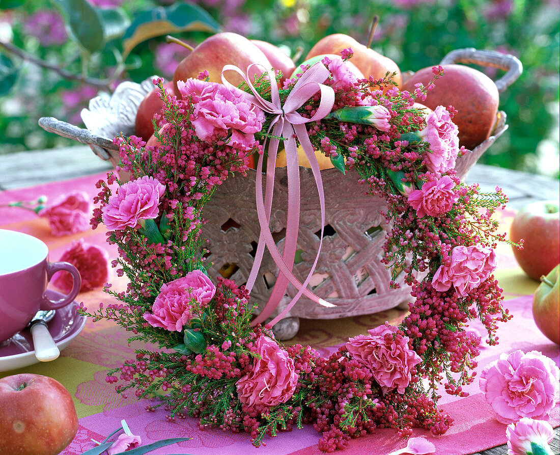 Erica and Dianthus wreath in basket with Malus