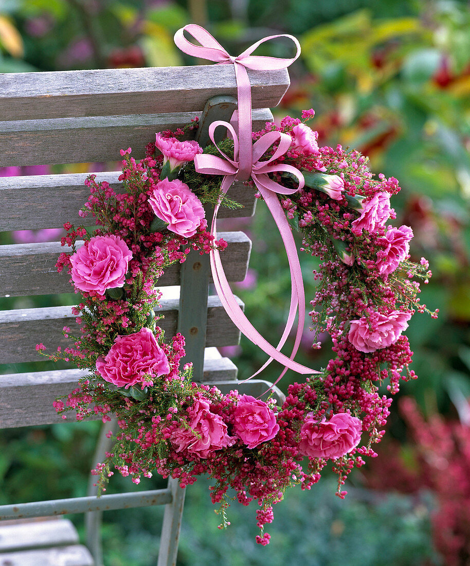 Wreath of Erica and Dianthus on back of wooden chair