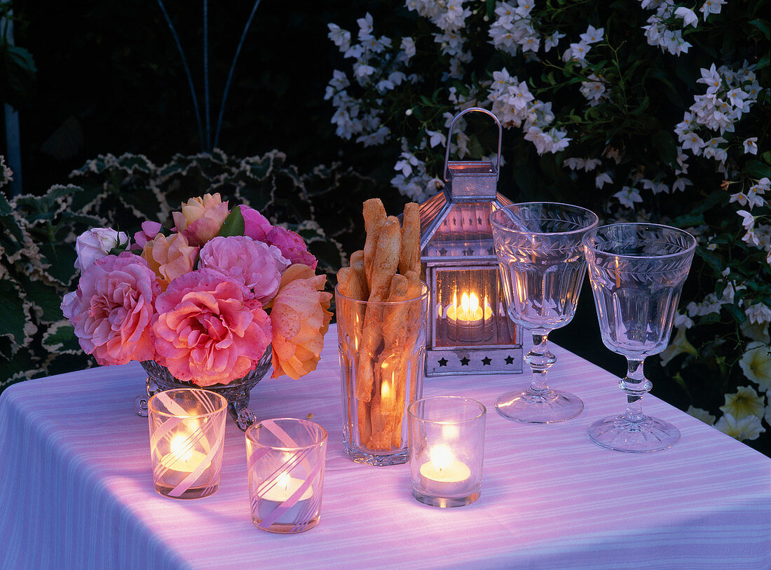 Small bouquet made of pink (rose), lantern, glasses, lanterns