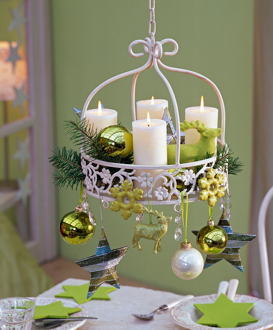 Hanging Christmas wreath with pseudotsuga, white candles, greens