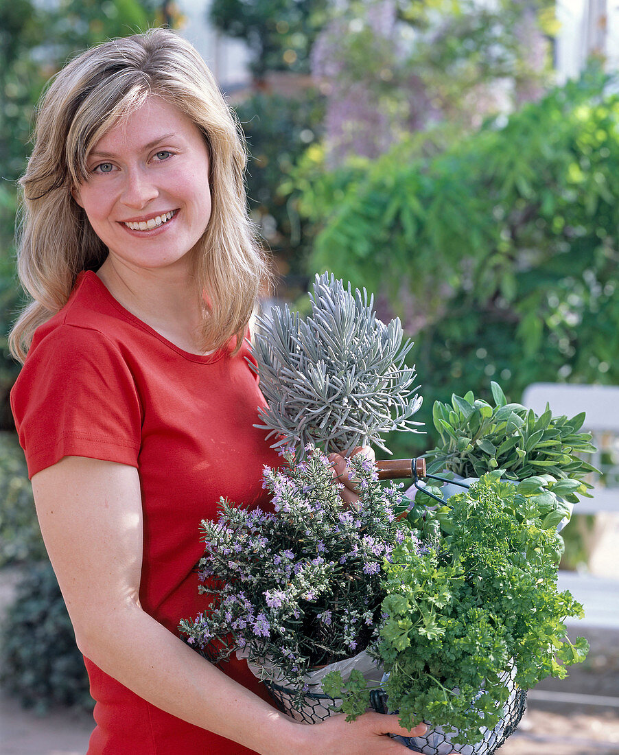 Young woman bought herbs, rosemary, petroselinum