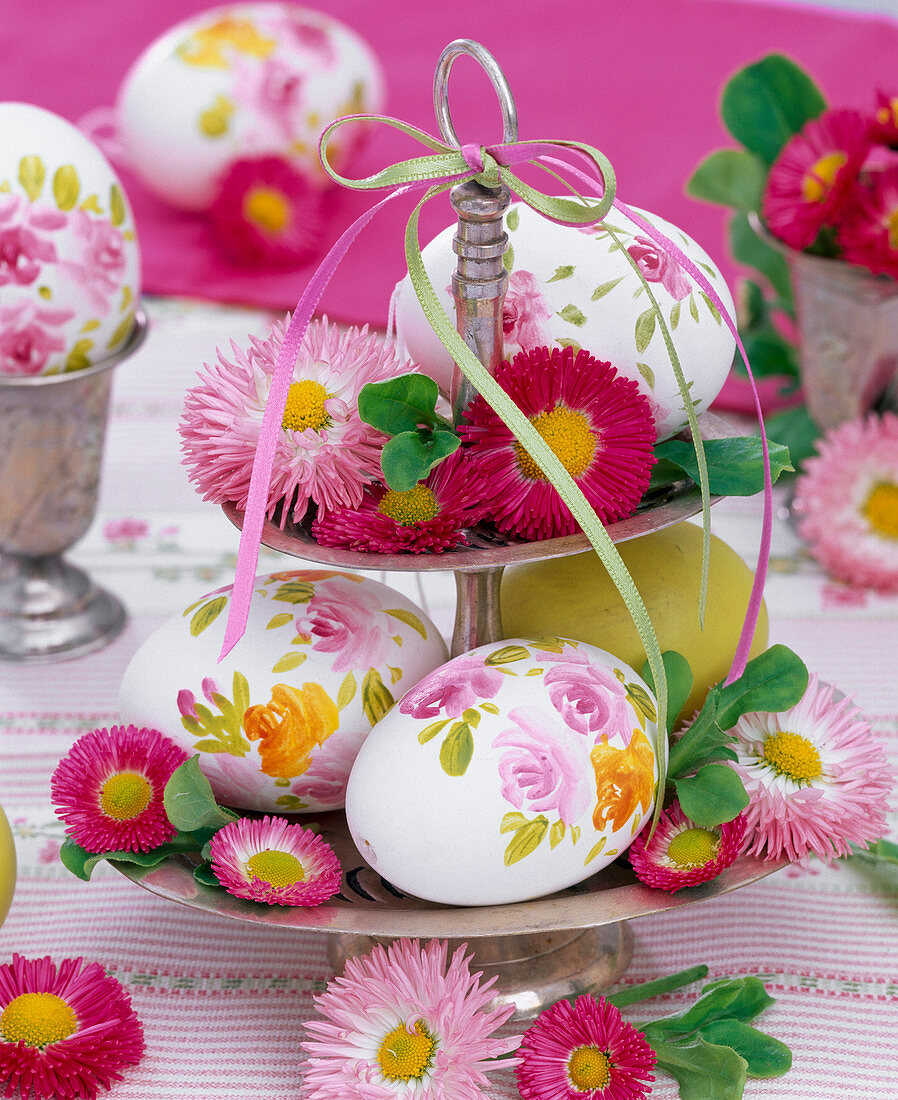 Bellis and painted eggs on silver etagere with ribbons