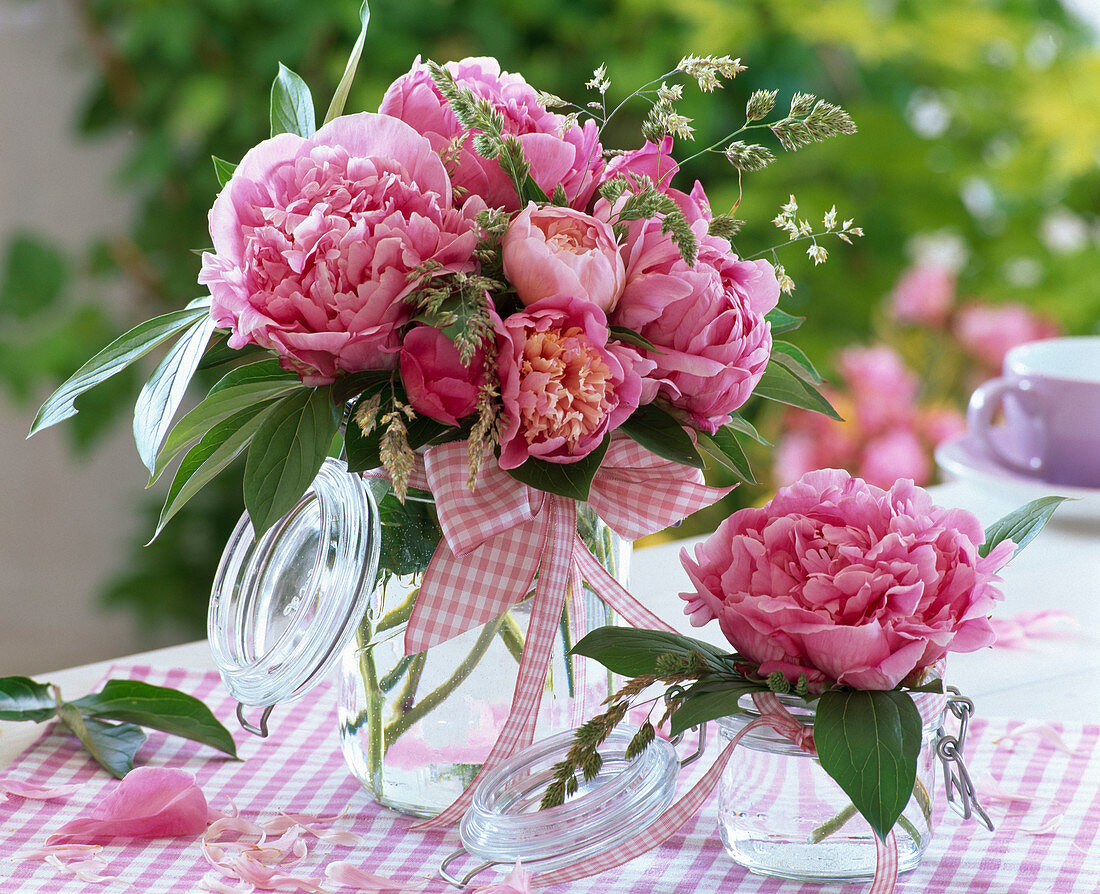 Paeonia (peony) and grasses in preserving jars