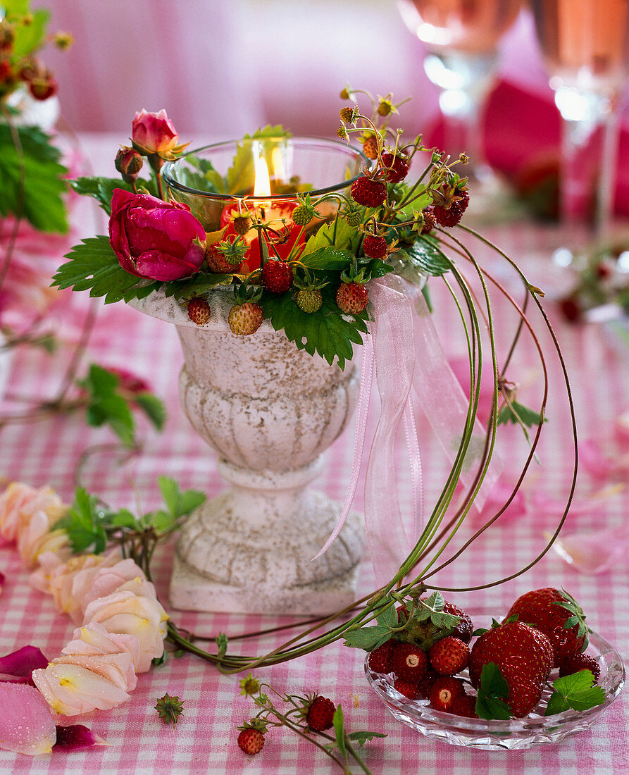 Wreath of Fragaria (wild strawberries) and pink (rose) around candle glass