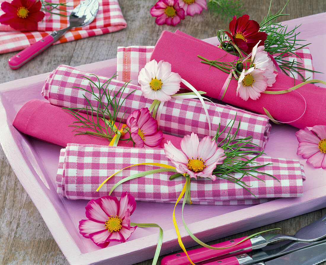 Cosmos on checkered and colored napkins on tray