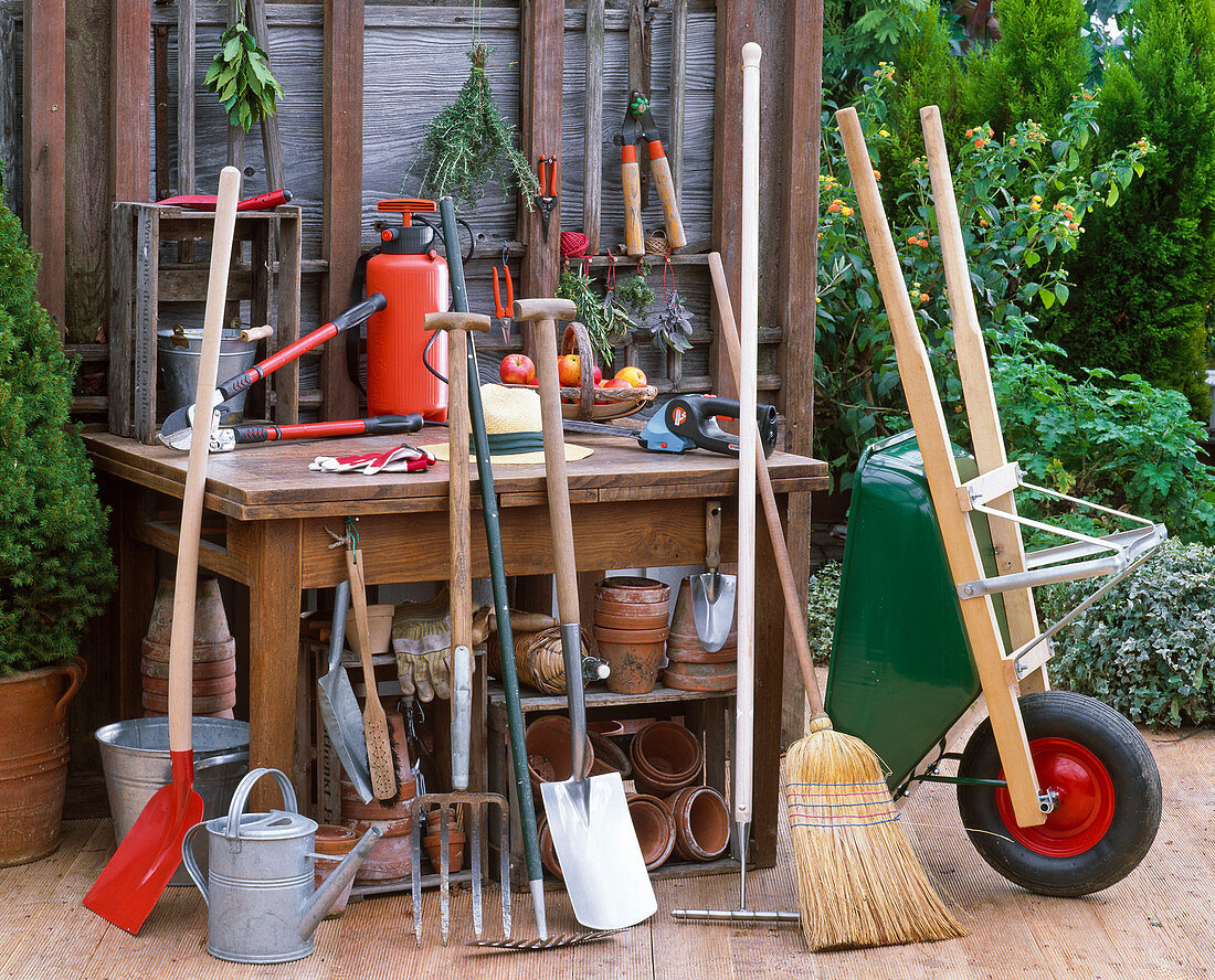 Garden tools on the terrace, shovel, watering can, grave fork, rake, spade