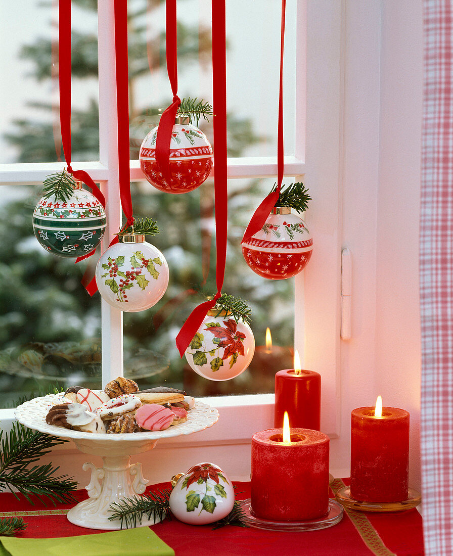 Christmas tree balls with Nordic motifs, hanging in the window