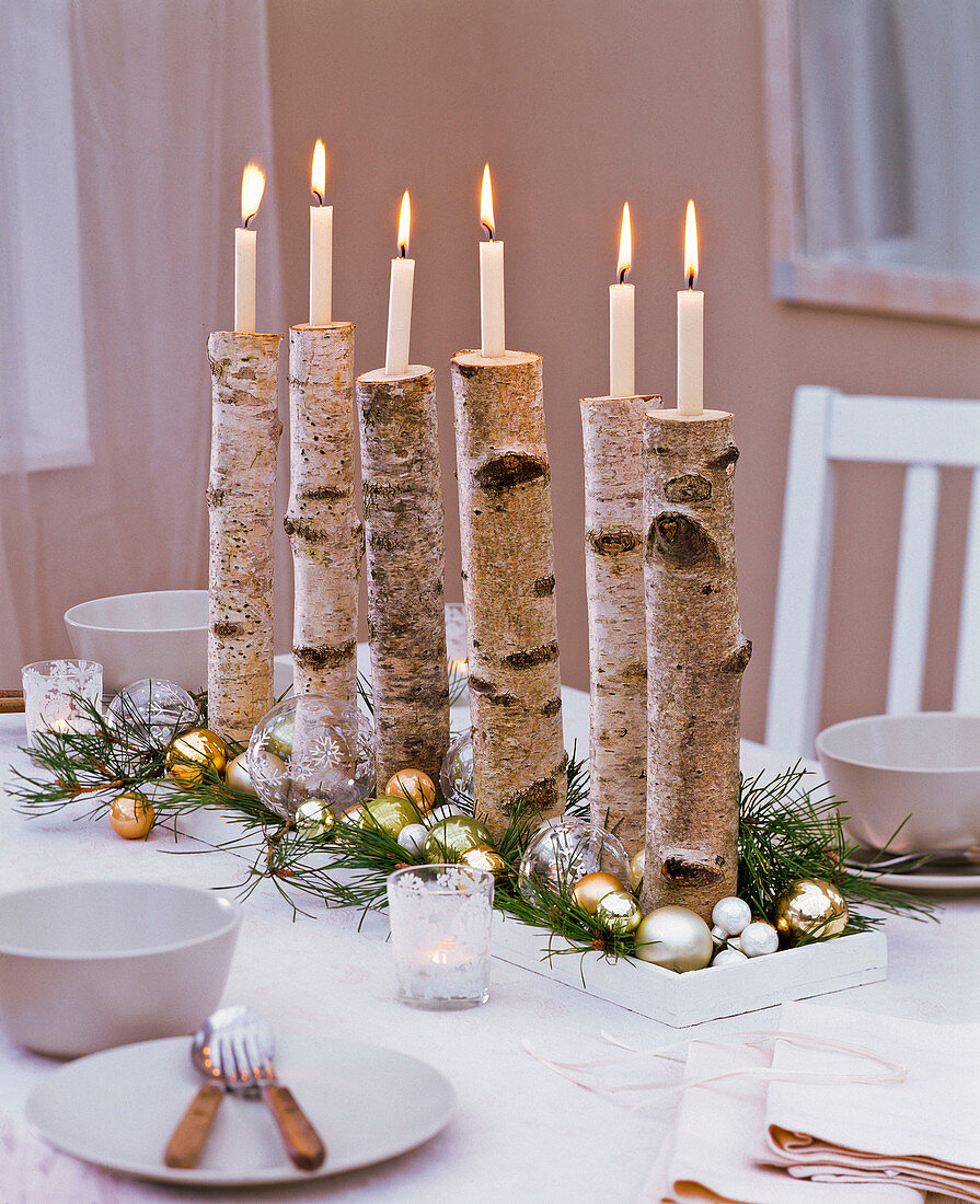 Christmas table decoration with betula branches as candlesticks