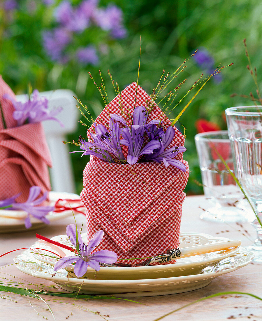 Folded napkins with agapanthus and panicum