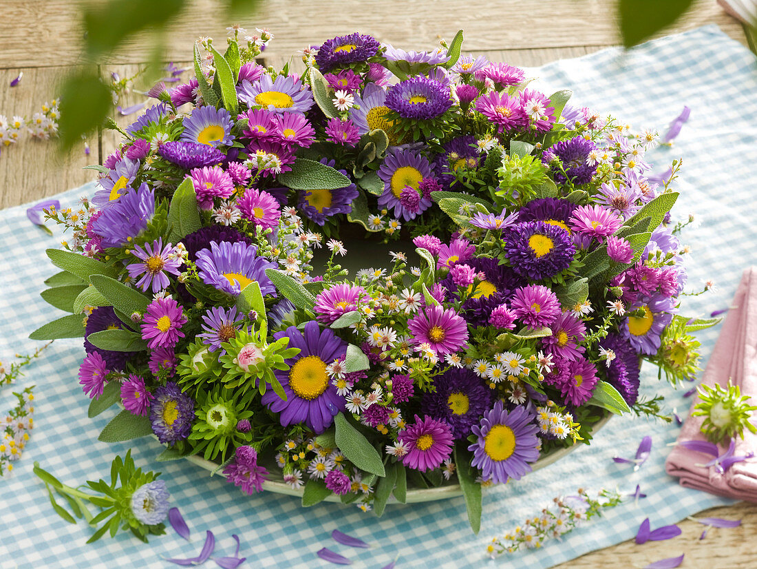 Blue-violet wreath of autumnal branches and summer asters
