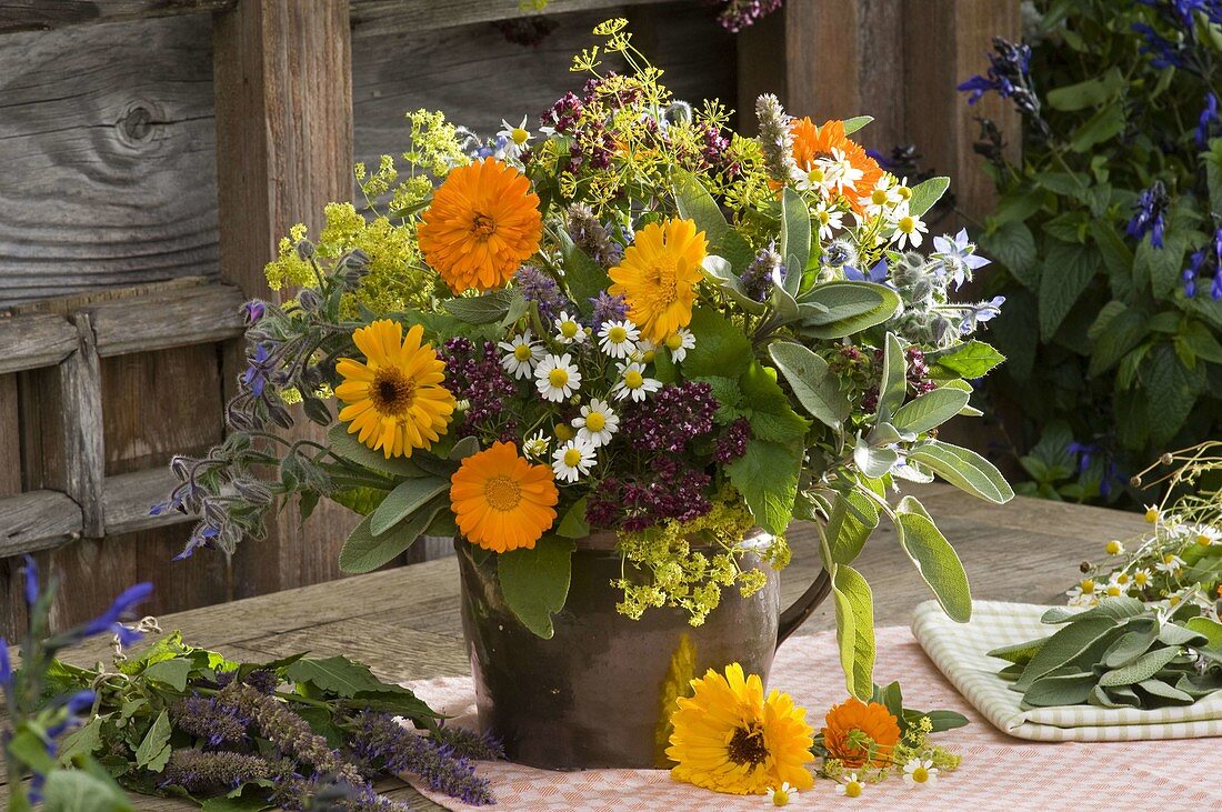 Herbal bouquet made of calendula (marigold), salvia (sage)
