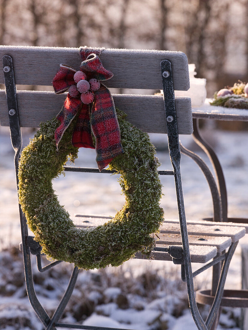 Moss wreath in hoarfrost with checkered bow