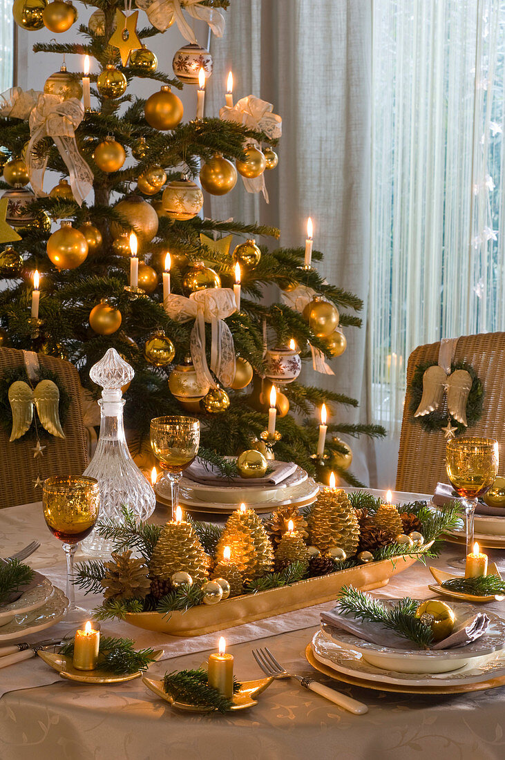 Advent arrangement in elongated gold bowl as table decoration