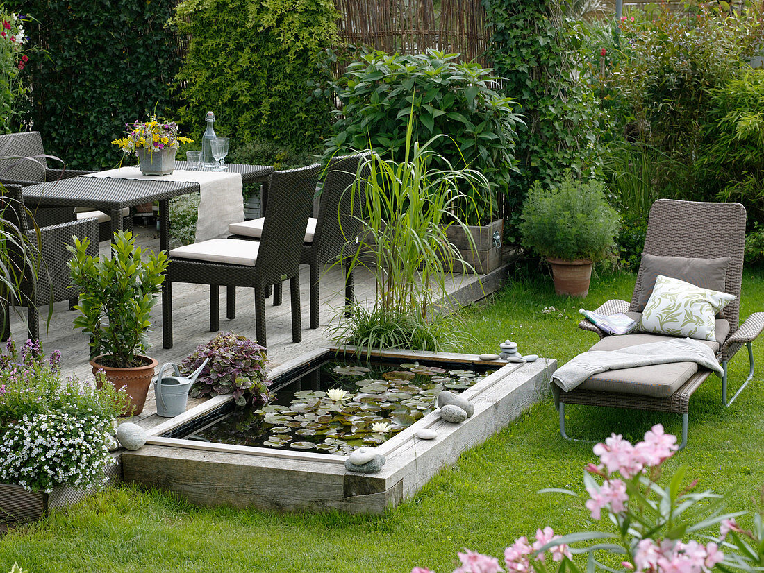 Build mini-pond out of flower bed with wooden border