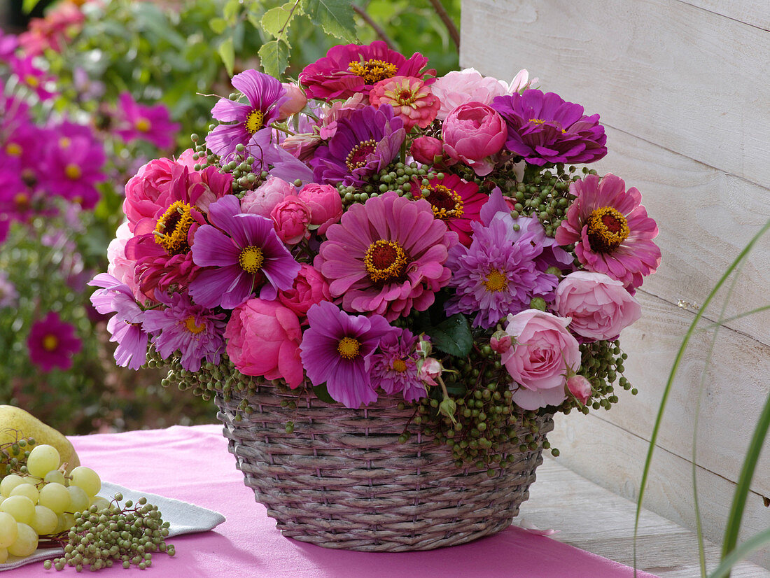 Pink late summer bouquet in basket vase