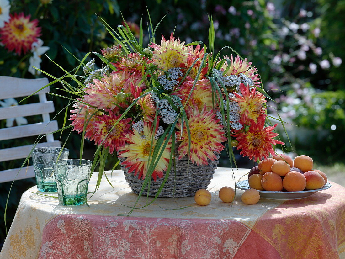Yellow-red Dahlia, Achillea, grasses in basket vase