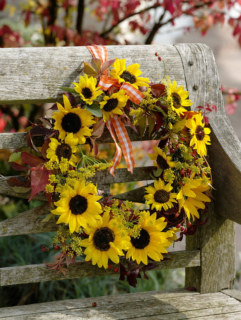 Autumn wreath made of sunflowers, fennel and wild wine