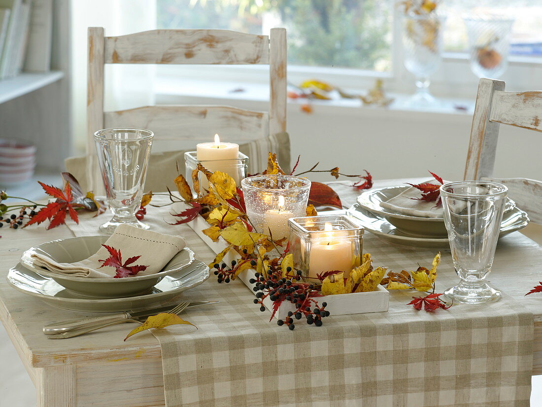 Fast, autumnal table decoration with red and yellow autumn leaves