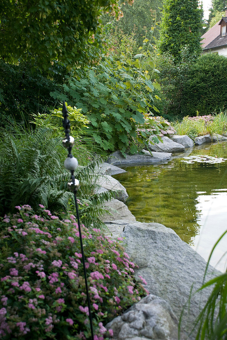 Garden pond edged with blocks of granite