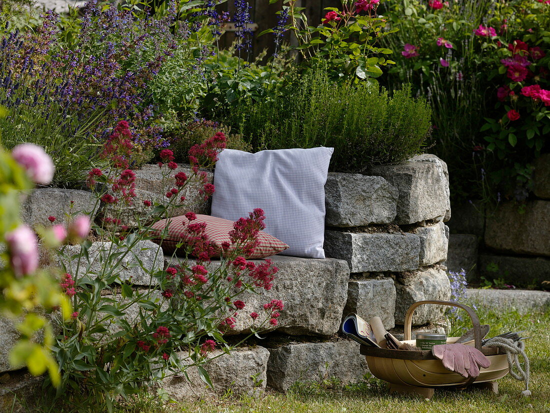 Dry stone wall of granite blocks with seating niche