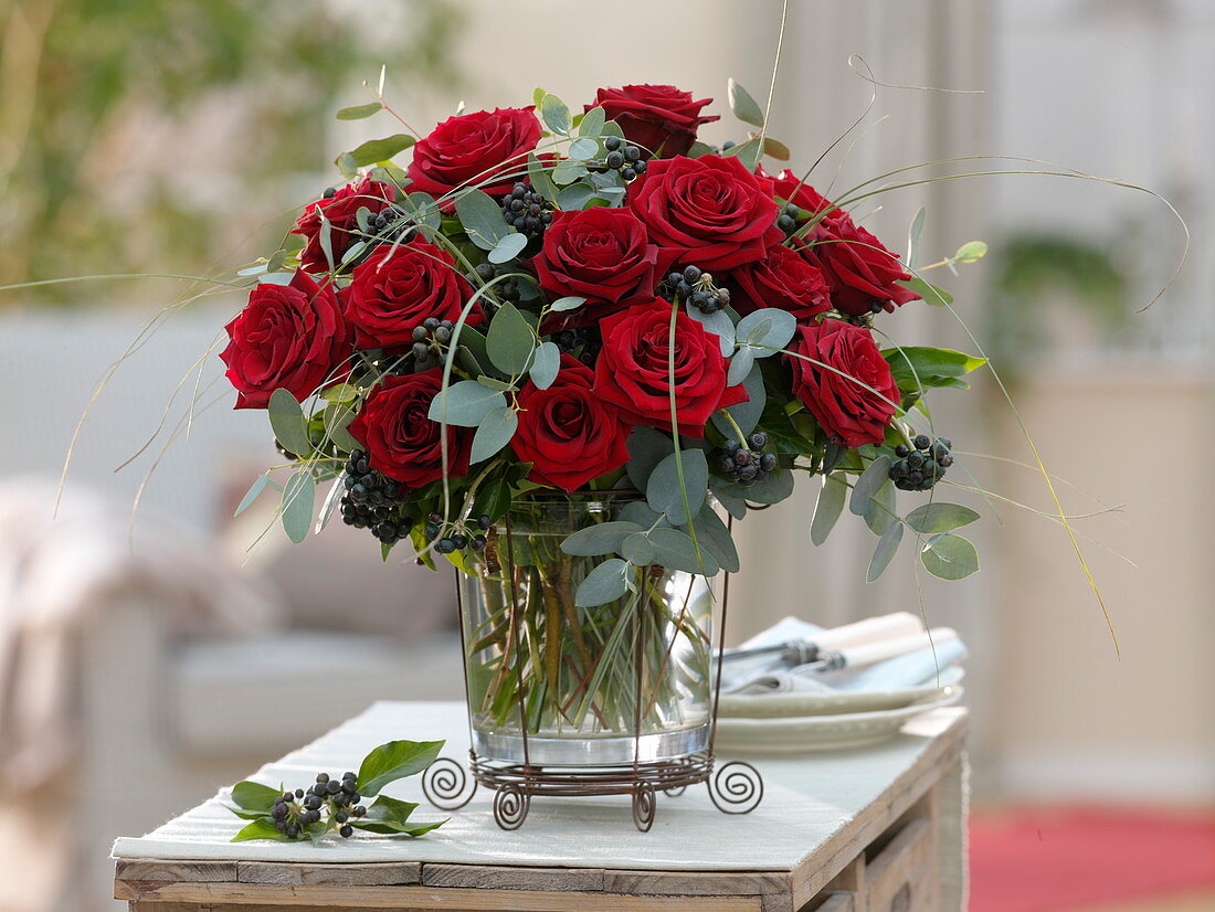 Winter bouquet made of red rose, eucalyptus, hedera