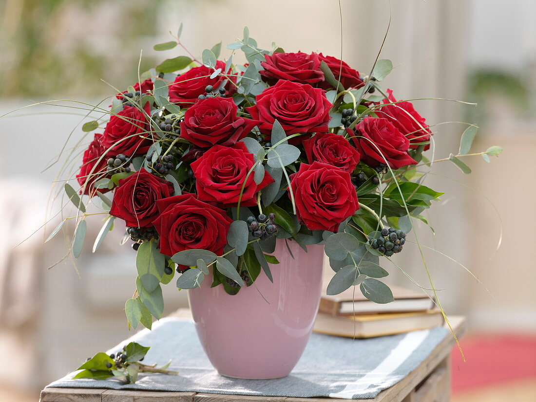 Winter bouquet made of red rose, eucalyptus, hedera