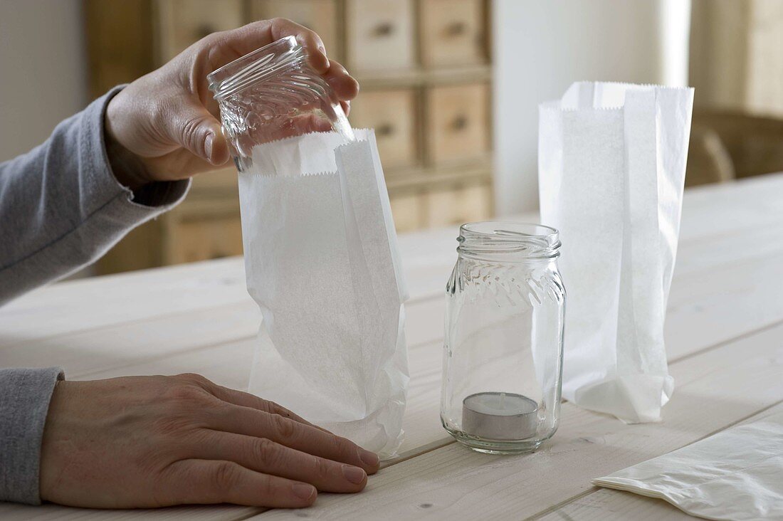 Lanterns with paper sandwish bags and coniferous branches