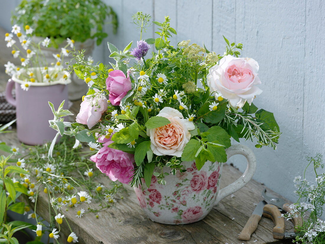 Scented and medicinal herbs bouquet in rose cup