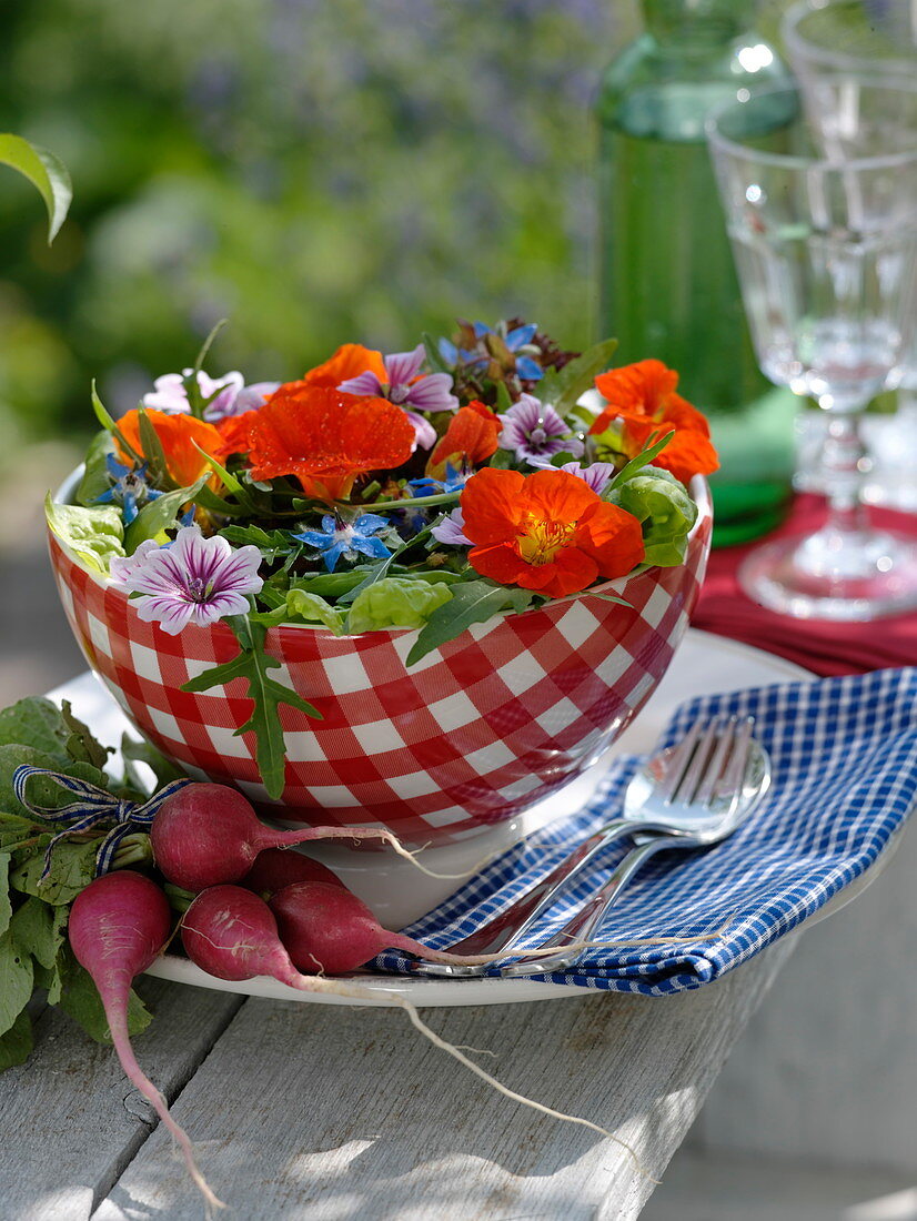 Colorful salad decorated with edible flowers