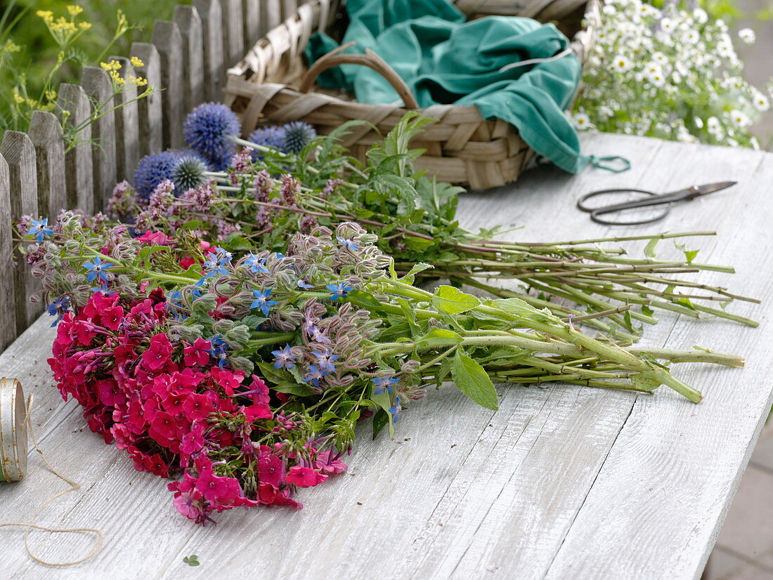 Blue-pink bouquet made of perennials and herbs
